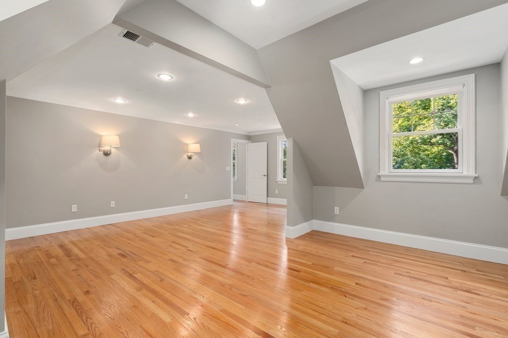 96 Crescent Street, Unit 96 Newton, MA 02466 - Photo 15 of 36 an empty room with wooden floor and windows