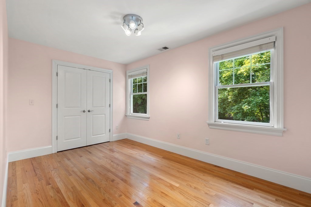96 Crescent Street, Unit 96 Newton, MA 02466 - Photo 20 of 36 a view of empty room with wooden floor and fan