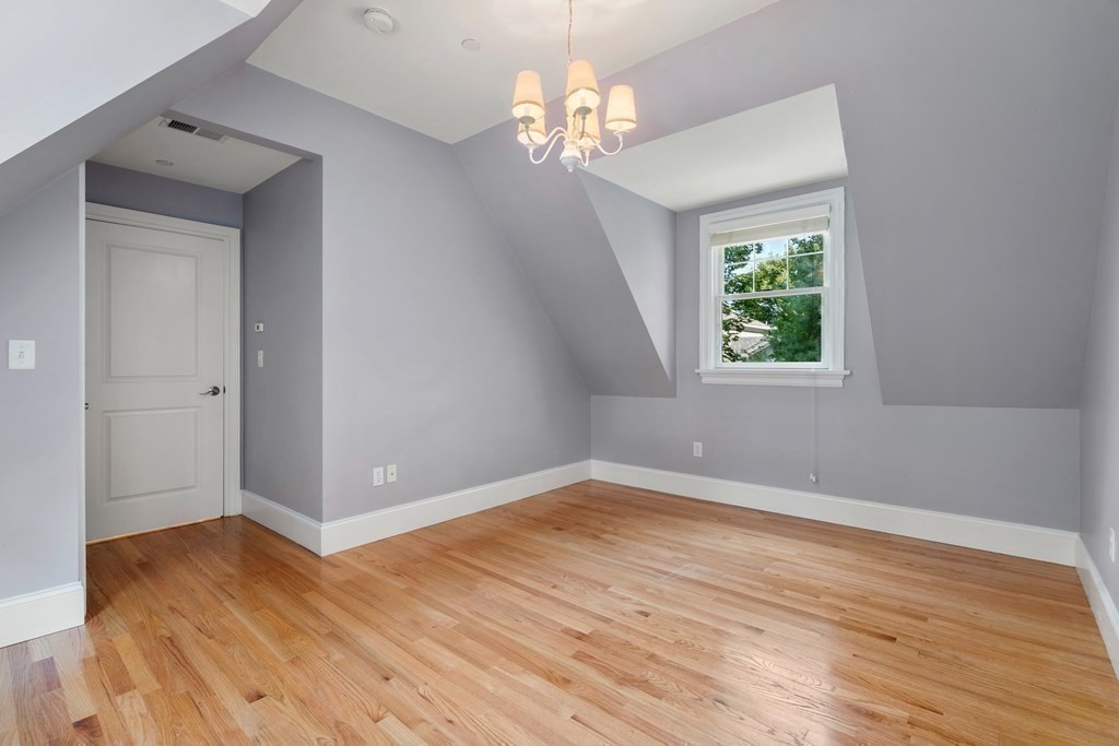96 Crescent Street, Unit 96 Newton, MA 02466 - Photo 22 of 36 wooden floor in an empty room with a window