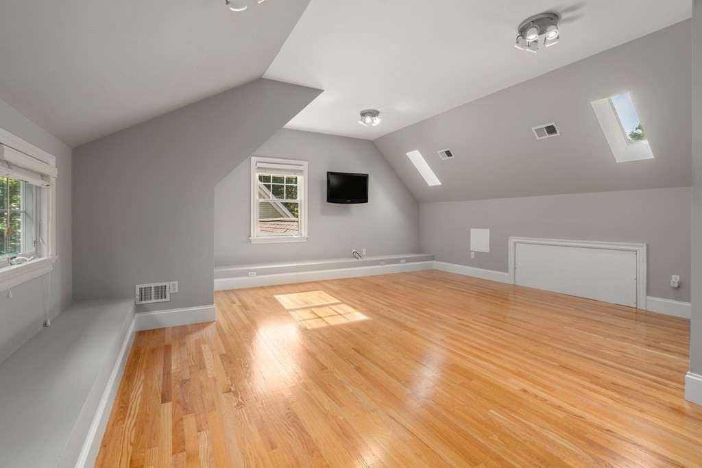 96 Crescent Street, Unit 96 Newton, MA 02466 - Photo 25 of 36 a view of empty room with wooden floor and fan