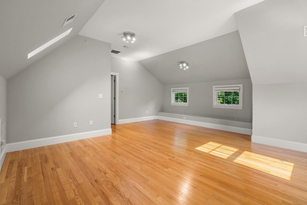 96 Crescent Street, Unit 96 Newton, MA 02466 - Photo 26 of 36 a view of an empty room with window and wooden floor