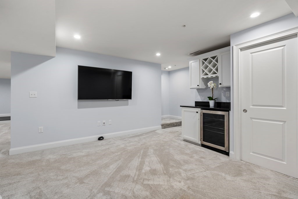96 Crescent Street, Unit 96 Newton, MA 02466 - Photo 27 of 36 a view of a livingroom with an empty space and a kitchen