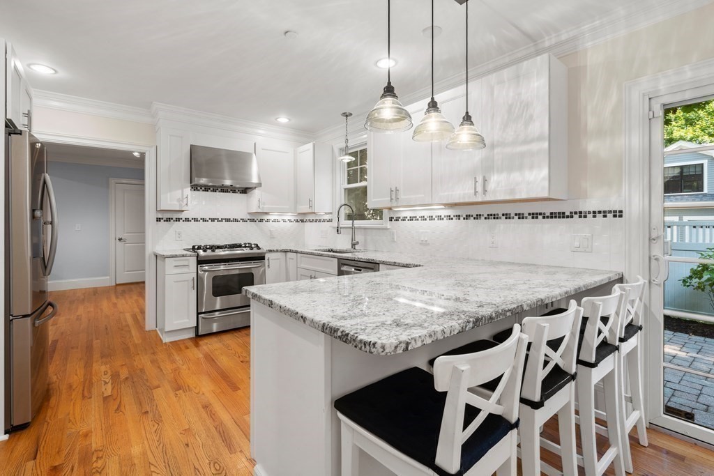 96 Crescent Street, Unit 96 Newton, MA 02466 - Photo 5 of 36 a kitchen with stainless steel appliances granite countertop a stove a sink and a refrigerator