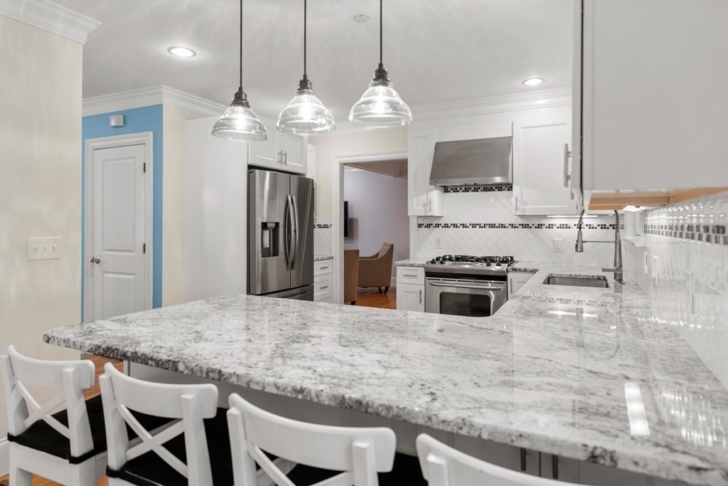 96 Crescent Street, Unit 96 Newton, MA 02466 - Photo 6 of 36 a kitchen with a table and chairs in it