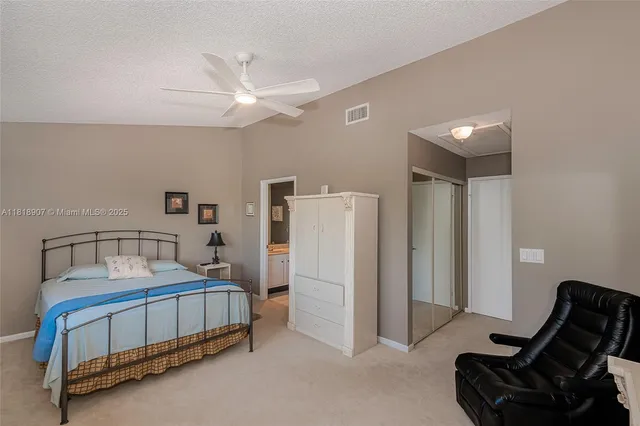 a bathroom with a toilet sink vanity and mirror