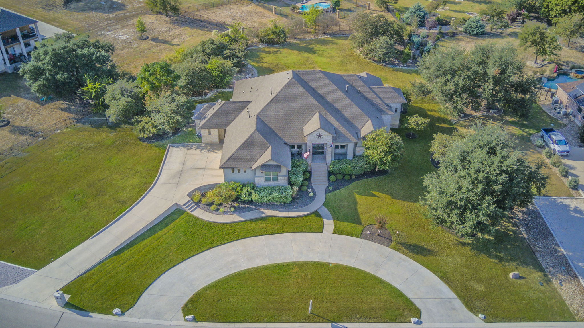 an aerial view of a house with swimming pool and outdoor seating
