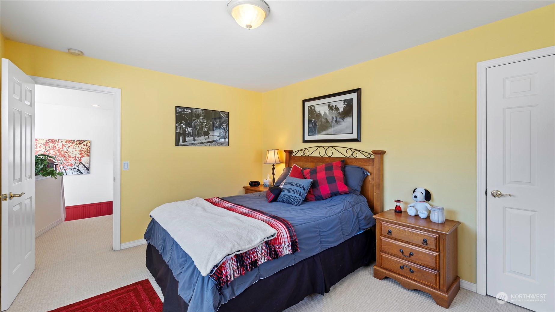 14293 Rosario Road Anacortes, WA 98221 - Photo 21 of 40 a bed room with a bed and paintings on the wall