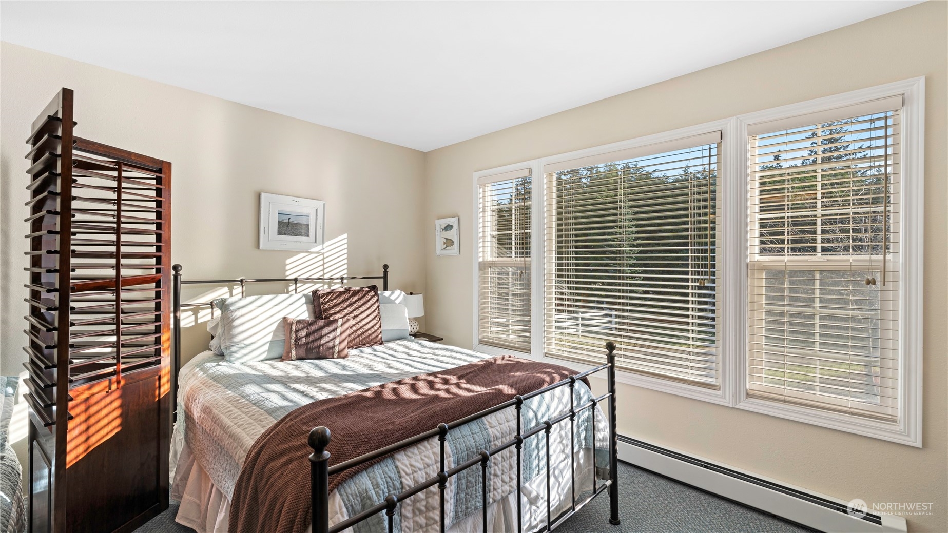 14293 Rosario Road Anacortes, WA 98221 - Photo 23 of 40 a bedroom with a bed and a window