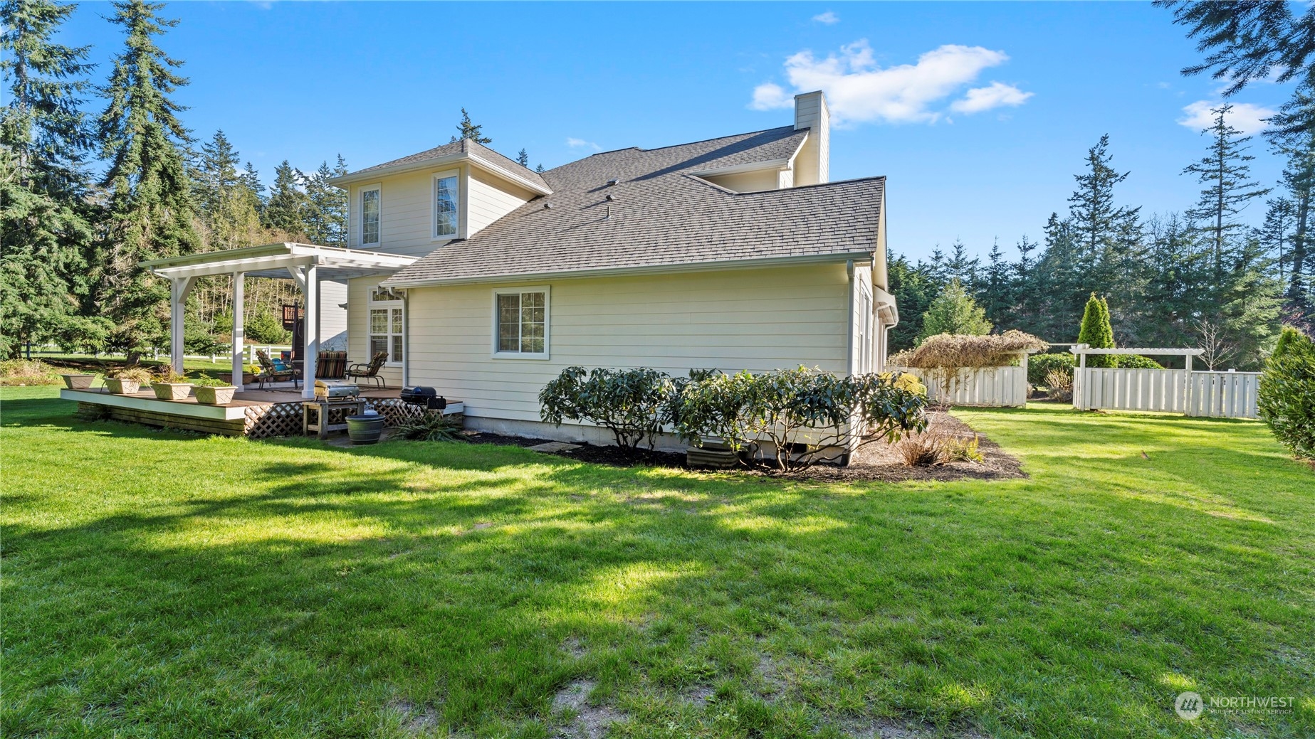14293 Rosario Road Anacortes, WA 98221 - Photo 36 of 40 a front view of a house with patio and garden