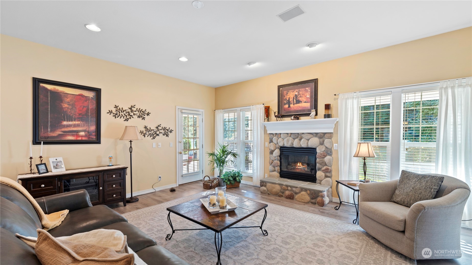 14293 Rosario Road Anacortes, WA 98221 - Photo 4 of 40 a living room with furniture a fireplace and a large window