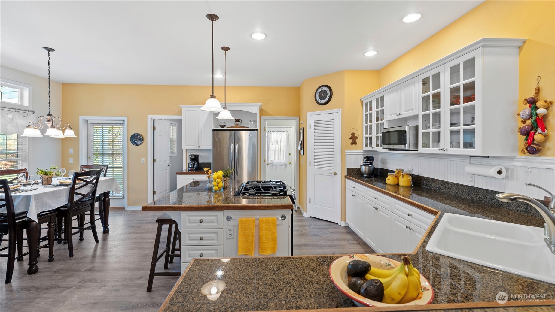14293 Rosario Road Anacortes, WA 98221 - Photo 7 of 40 a kitchen with a sink a stove and chairs