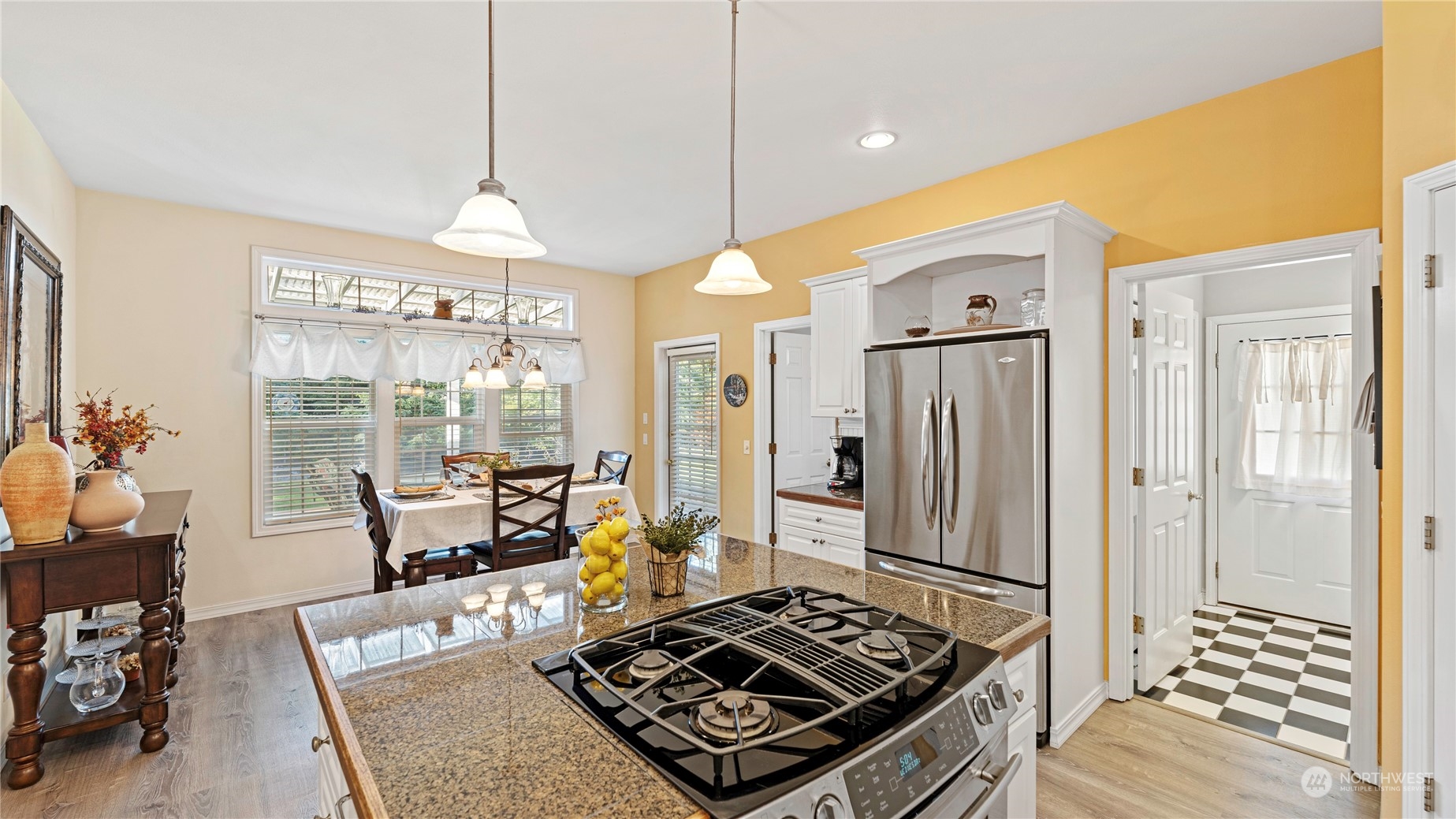 14293 Rosario Road Anacortes, WA 98221 - Photo 10 of 40 a kitchen with a stove a refrigerator and a dining table