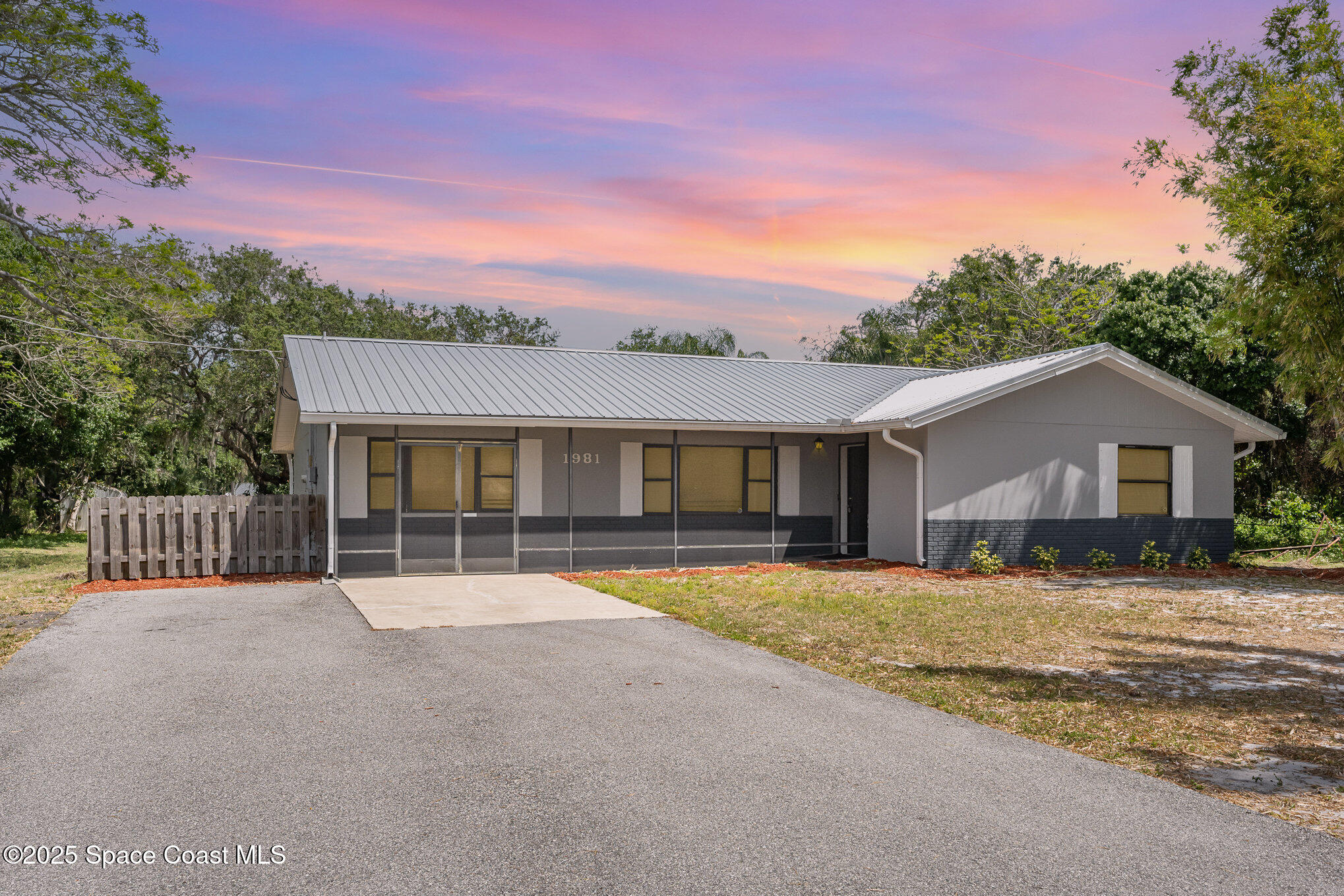 1981 Roc Rosa Drive Northeast Palm Bay, FL 32905 - Photo 1 of 29 a view of a house with a yard and fence