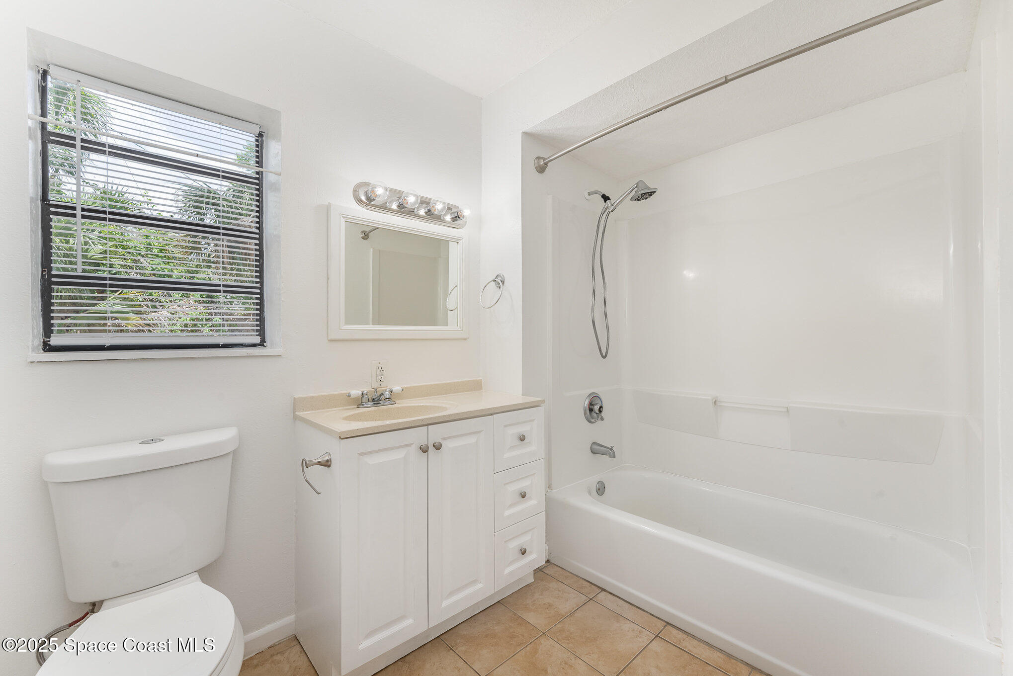 1981 Roc Rosa Drive Northeast Palm Bay, FL 32905 - Photo 14 of 29 a bathroom with a granite countertop toilet a sink and a bathtub