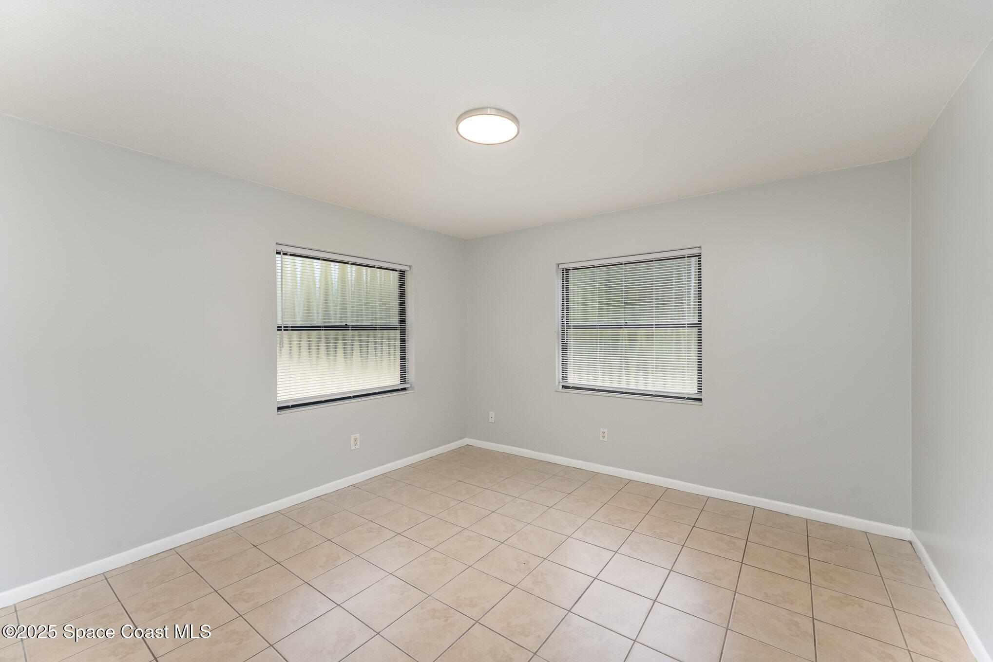 1981 Roc Rosa Drive Northeast Palm Bay, FL 32905 - Photo 18 of 29 a view of an empty room with a window