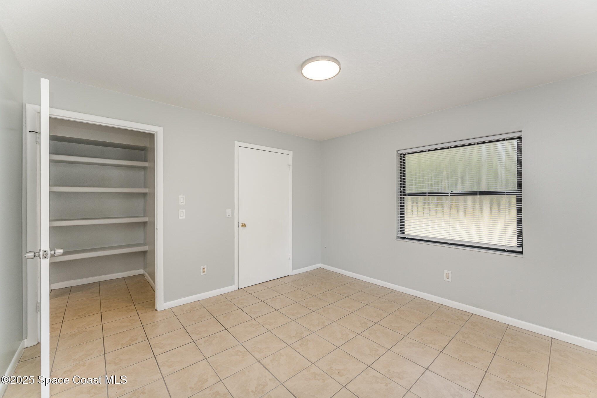 1981 Roc Rosa Drive Northeast Palm Bay, FL 32905 - Photo 19 of 29 a view of an empty room with a window