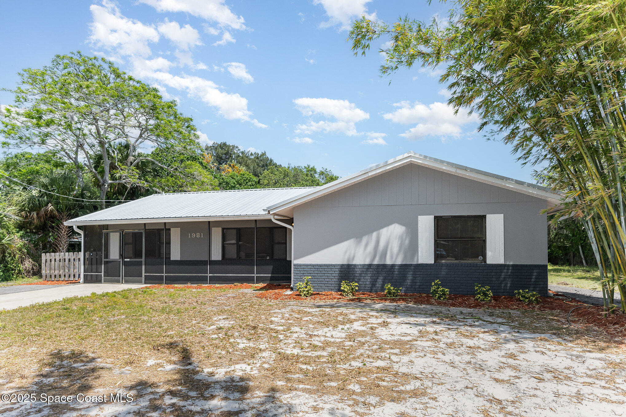 1981 Roc Rosa Drive Northeast Palm Bay, FL 32905 - Photo 2 of 29 a front view of a house with garden