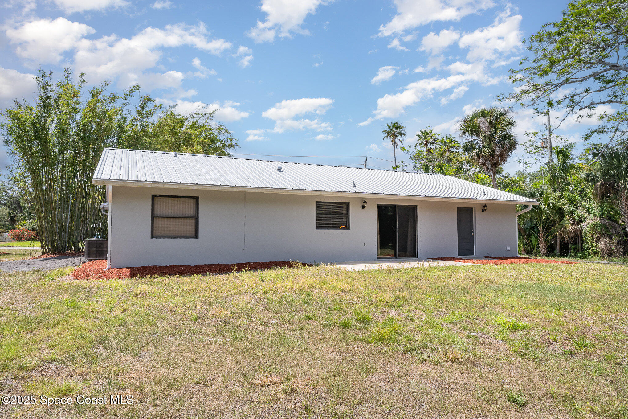 1981 Roc Rosa Drive Northeast Palm Bay, FL 32905 - Photo 22 of 29 a view of a house with a yard