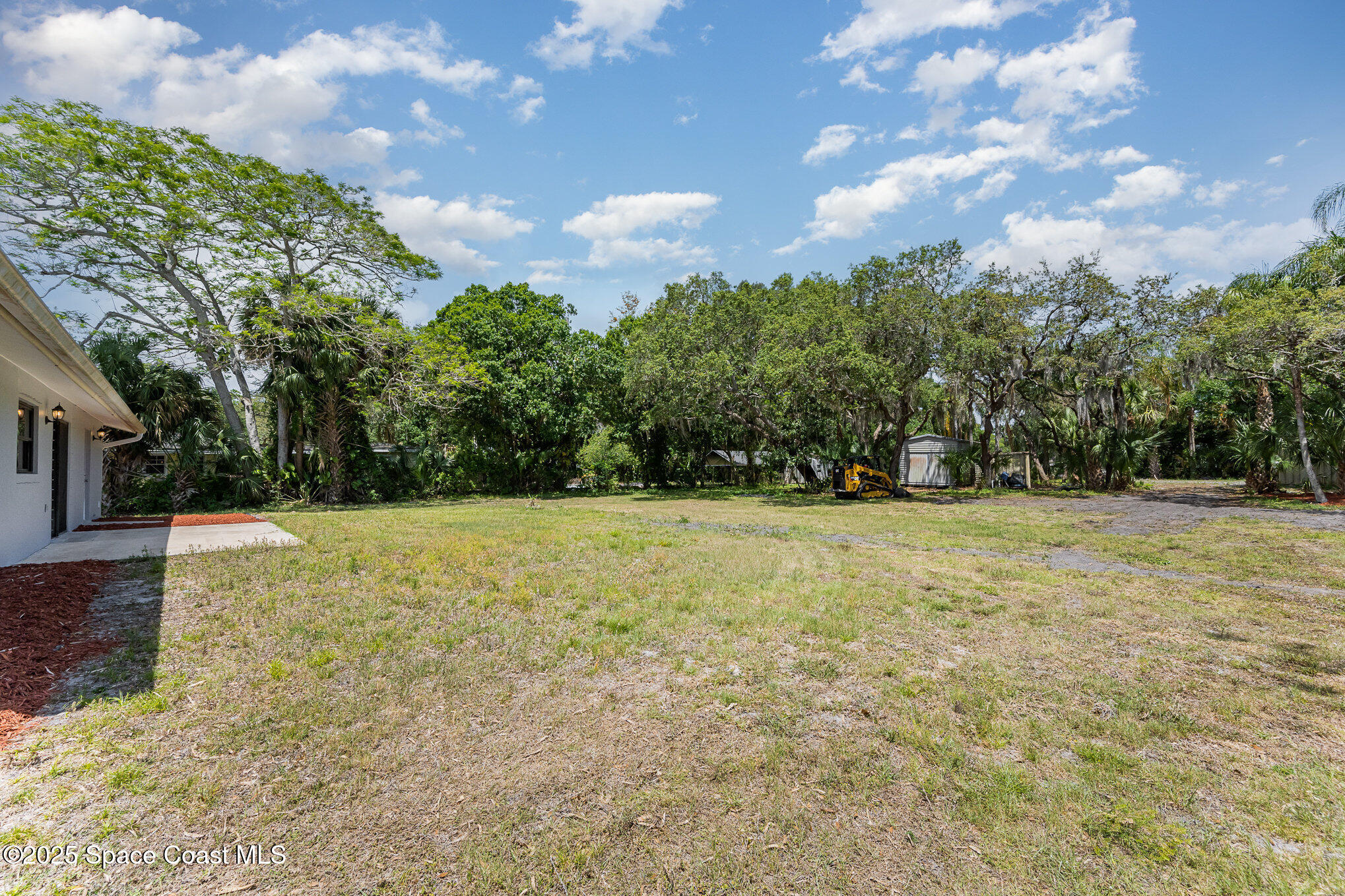 1981 Roc Rosa Drive Northeast Palm Bay, FL 32905 - Photo 23 of 29 a view of outdoor space with deck and trees
