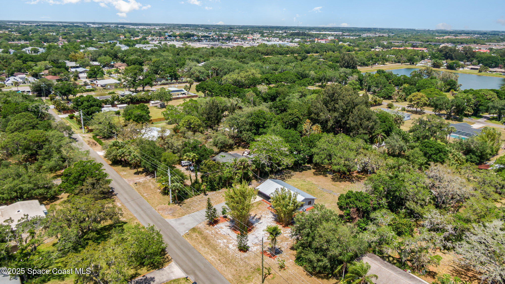 1981 Roc Rosa Drive Northeast Palm Bay, FL 32905 - Photo 27 of 29 a view of a city with lush green forest