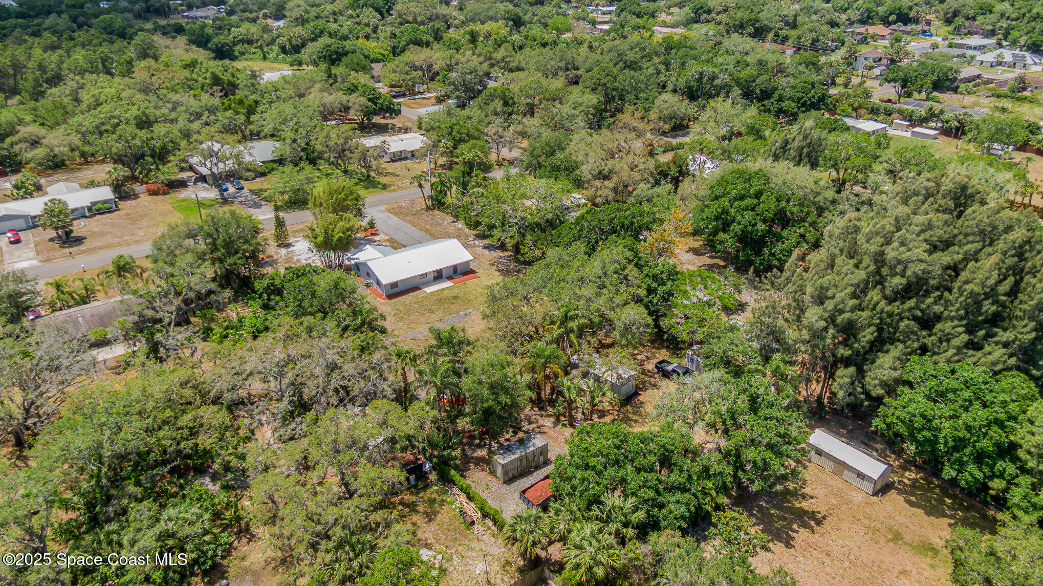 1981 Roc Rosa Drive Northeast Palm Bay, FL 32905 - Photo 28 of 29 an aerial view of residential house with outdoor space and trees all around