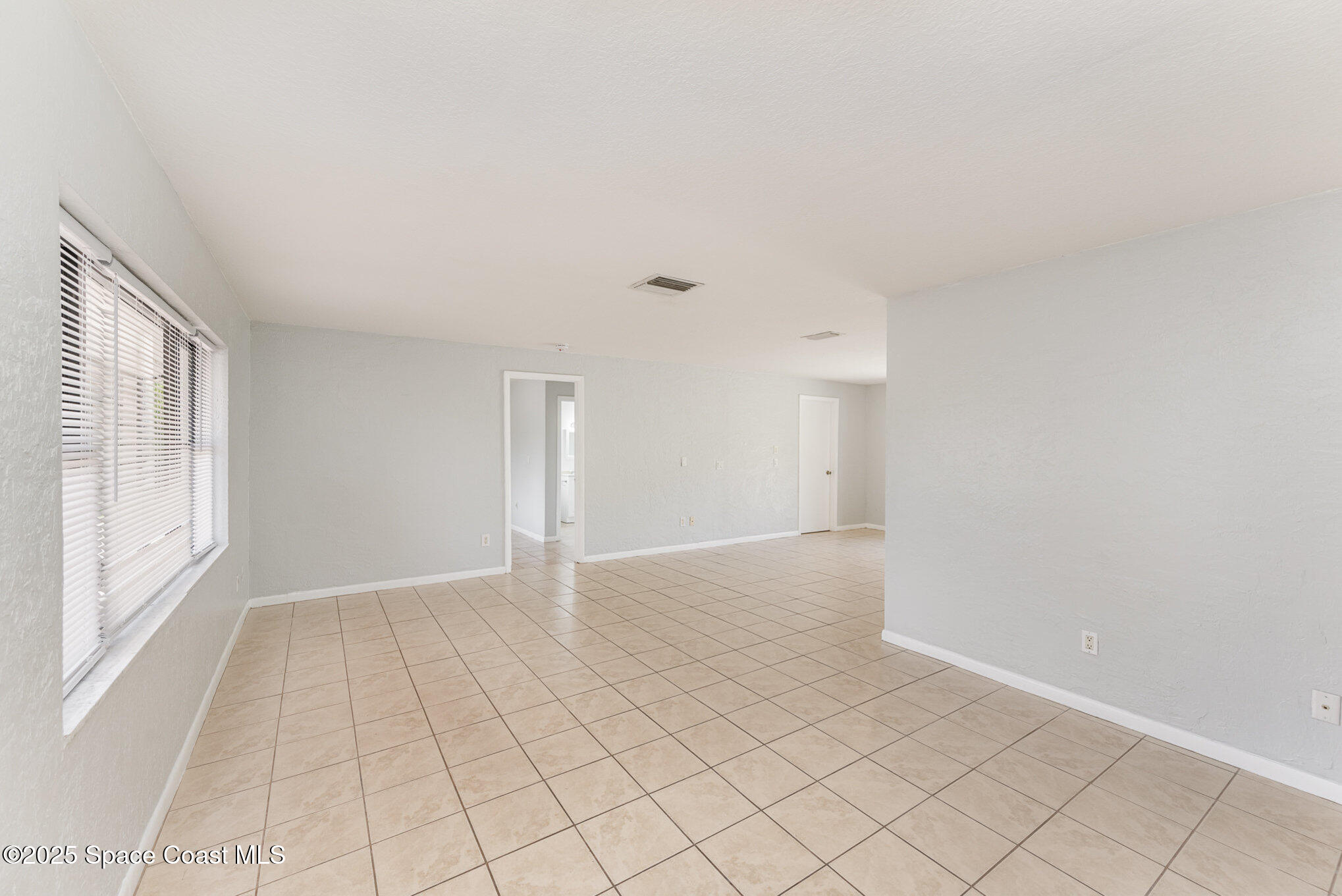 1981 Roc Rosa Drive Northeast Palm Bay, FL 32905 - Photo 4 of 29 a view of an empty room and window