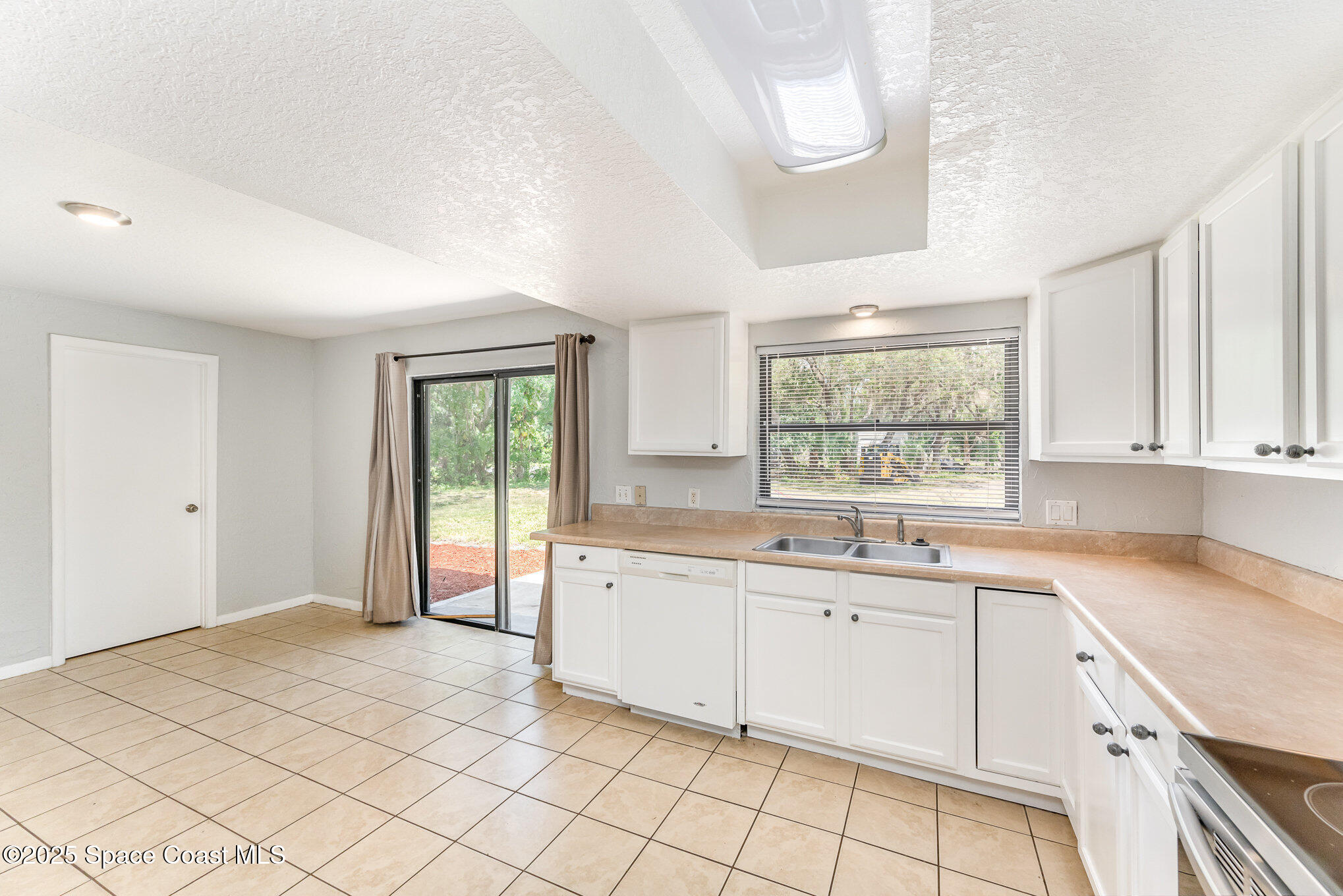 1981 Roc Rosa Drive Northeast Palm Bay, FL 32905 - Photo 8 of 29 a kitchen with a sink cabinets and window