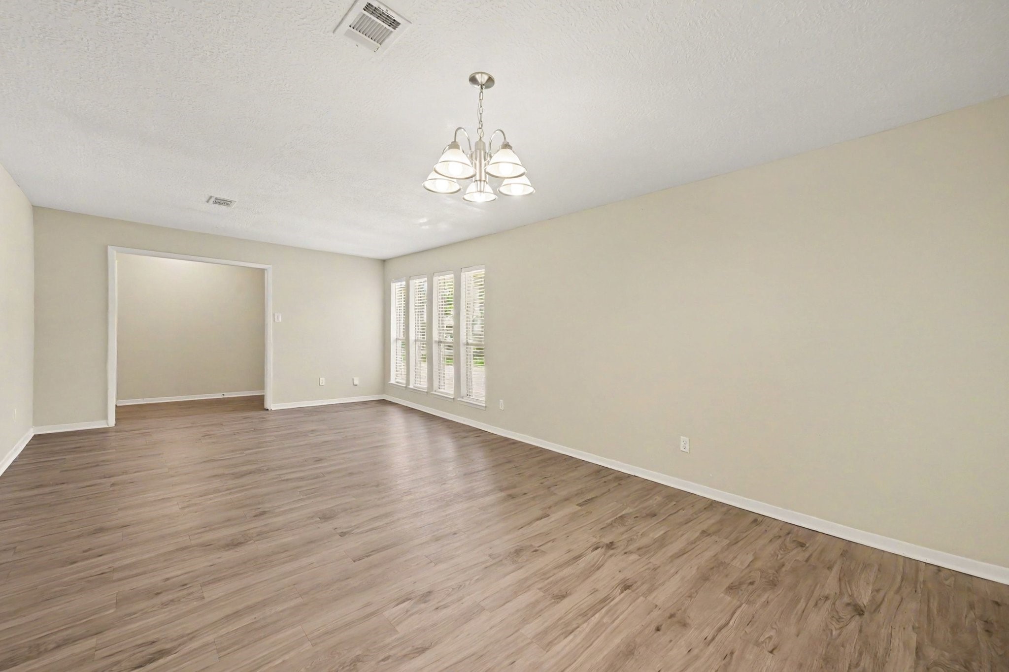 17419 Cassina Drive Spring, TX 77388 - Photo 7 of 35 a view of an empty room with wooden floor and a window