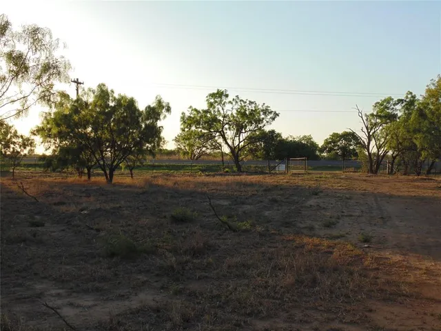 a view of outdoor space with green field and trees