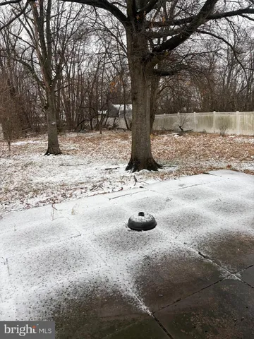 a view of a yard covered in snow
