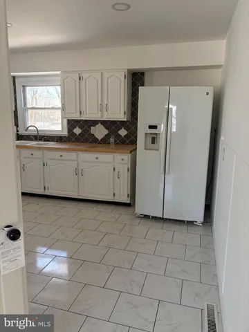 a kitchen with cabinets and window