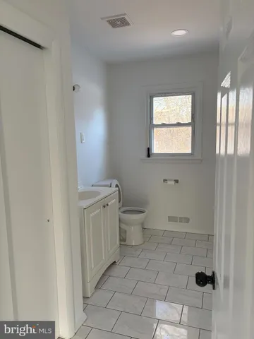 a bathroom with a toilet sink and window