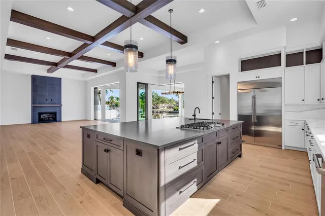 a kitchen with stainless steel appliances granite countertop a large counter top a stove and a refrigerator