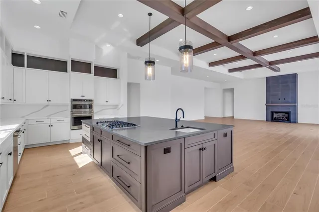 a kitchen with stainless steel appliances granite countertop a sink and cabinets