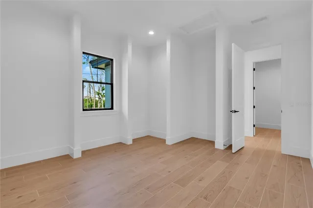 a spacious bathroom with a granite countertop sink a toilet and bathtub