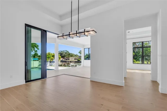 a view of a room with a floor to ceiling window and wooden floor