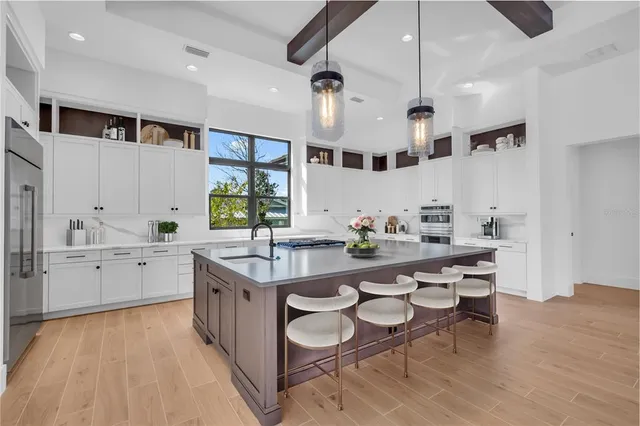 a large kitchen with a table and chairs in it