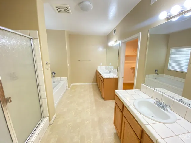 a bathroom with a sink a mirror and a shower
