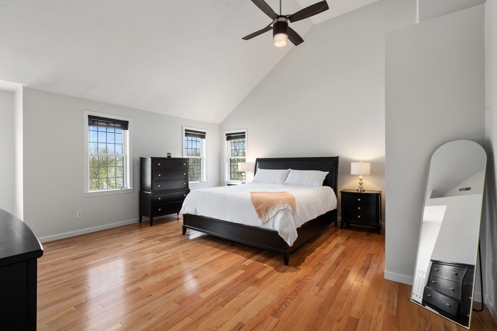 45 Cinnamon Ridge Circle Middleboro, MA 02346 - Photo 18 of 38 a spacious bedroom with a bed and wooden floor