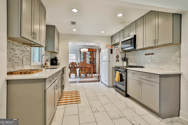 a kitchen with stainless steel appliances granite countertop a sink and cabinets