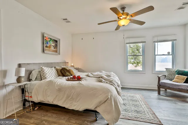 a bed sitting in a bedroom next to a window