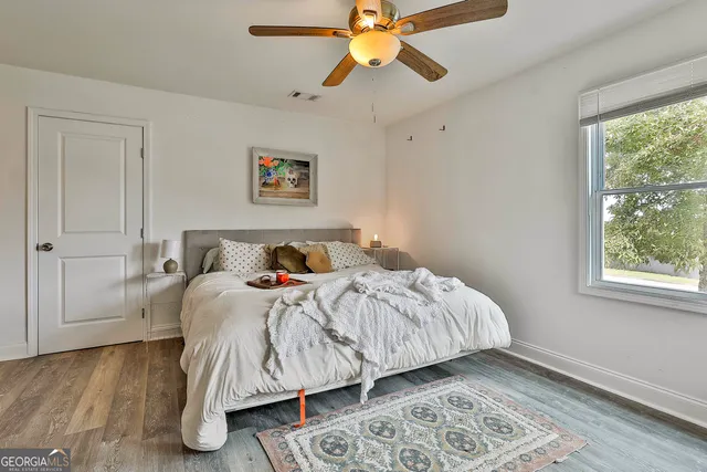 a bedroom with a bed and a window