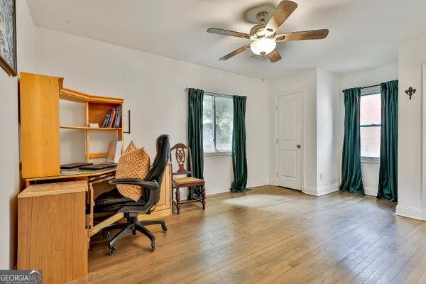 a view of a workspace with furniture and a window