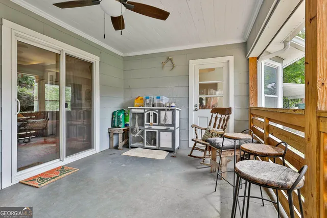 a view of backyard with outdoor seating and trees
