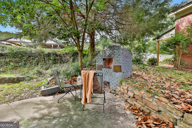 a backyard of a house with table and chairs