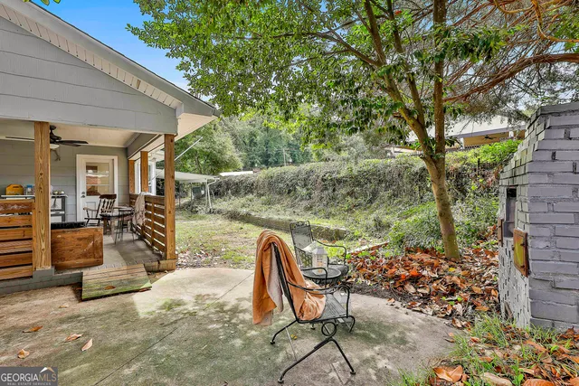 a view of a house with a yard and sitting area
