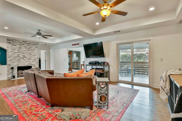 a living room with furniture a fireplace and a flat screen tv