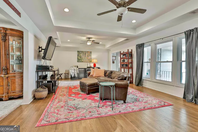 a living room with furniture rug and a window