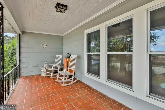a view of a chairs and table in a patio