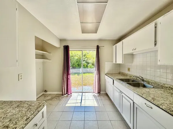 a kitchen with a stove a sink and a refrigerator